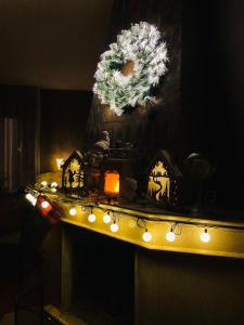 a counter with lights and a wreath on a wall at BFG Suites Leselidze in Tbilisi City