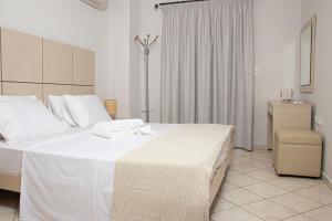 Ένα ή περισσότερα κρεβάτια σε δωμάτιο στο SALTSEA BOUTIQUE VILLAS