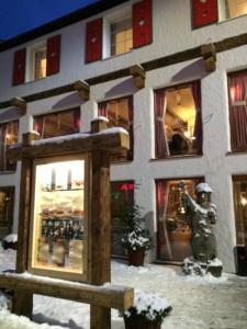 a snow covered building with a statue in front of it at POD TĘŻNIĄ in Szczyrk