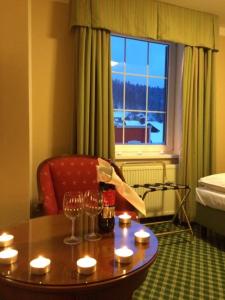 a room with a table with wine glasses and a window at POD TĘŻNIĄ in Szczyrk