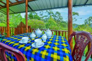 a table with a blue and yellow checkered table cloth at Astral Zone Cottage ELLA in Ella