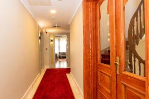 a hallway with a red carpet and an open door at Blue Gilroy Hotel in Istanbul +117 photos