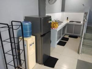 a kitchen with a stainless steel refrigerator and a counter at Villa Bella 2 Private Resort in Calamba