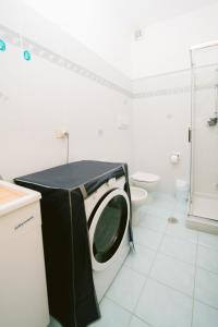 a washing machine in a bathroom with a toilet at Rosemary Holiday House in Conca dei Marini