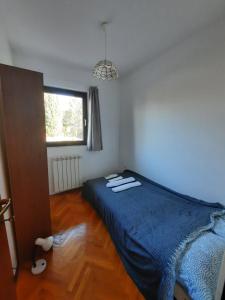 a bedroom with a bed with two towels on it at Apartments Mateo in Zagreb