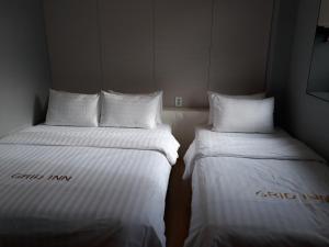 Postel nebo postele na pokoji v ubytování Grid Inn Hotel