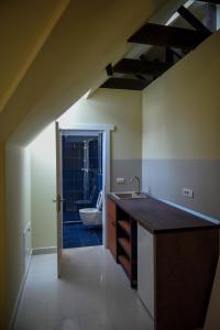 a bathroom with a sink and a toilet in a room at Schloss Apartments in Braşov