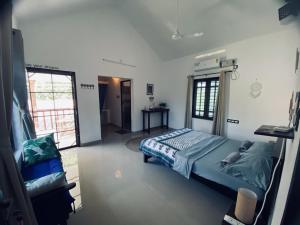 a bedroom with a bed and a window at Tamarind Villa in Varkala