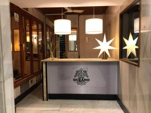 a lobby with a counter with stars on the wall at Hotel Océano Centro in Santa Cruz de Tenerife