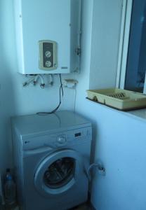 a washing machine in a bathroom with a mirror at Beautiful appartment with a glorious sea view in Monastir