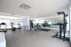 a gym with several treadmills and machines in a room at APARTMENTS GH - Accra - Cantonments - Embassy Gardens in Accra