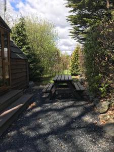 a picnic table in front of a cabin at Cartmel Camping Pod in Cartmel