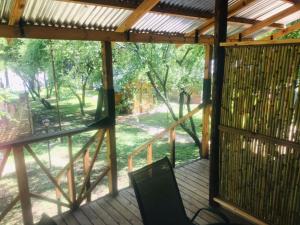 a screened porch with a view of the woods at Serenity Guesthouse in Klerksdorp