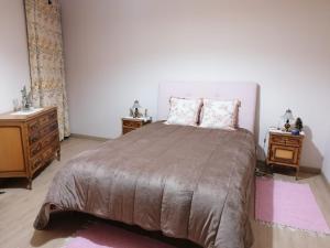 a bedroom with a large bed and two night stands at Casa do Bonifácio in Vilarinho
