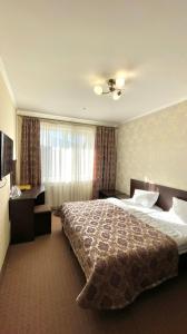 a hotel room with a large bed and a window at Mountain Lift 7 Hotel in Bukovel +29 photos