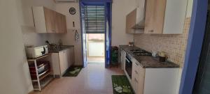 a kitchen with a sink and a stove top oven at La Casa di Pietro in Sapri