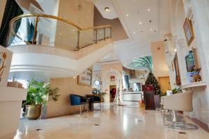 a lobby with a spiral staircase in a building at Grand Continental Hotel in Abu Dhabi