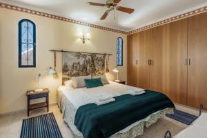 a bedroom with a large bed and a ceiling fan at Villa Nerja Views Mediterranean Panorama in Nerja +38 photos