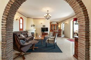 an archway in a living room with a couch and chairs at Villa Nerja Views Mediterranean Panorama in Nerja