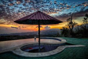 a large umbrella sitting on top of a pool at Dream Villa, Ocean View & Pool! in San Ramón