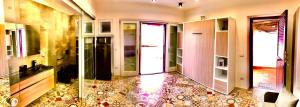 a bathroom with a tiled floor and glass doors at Apartment Suite residence al porto Vulcano in Vulcano