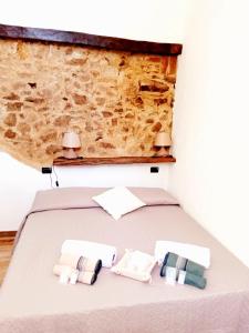 sypialnia z łóżkiem z dwoma ręcznikami w obiekcie Un Tuffo nel passato "B&B Santu Giuvanni" w mieście Fonni