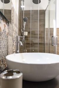 a white sink in a bathroom with a shower at Alloggio Turistico Puccini in Perugia