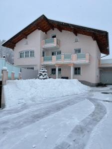 a pile of snow in front of a house at Appartment Schmidl in Bischofshofen