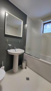 a bathroom with a sink and a mirror at 50m from Ski Piste 1 BR Apartment in Predela 2 in Bansko +17 photos