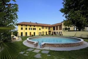 a large house with a swimming pool in the yard at Agriturismo Podere La Piazza in Costigliole dʼAsti
