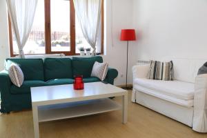a living room with a green couch and a white coffee table at 50m from Ski Piste 1 BR Apartment in Predela 2 in Bansko