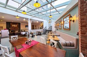 a dining room with wooden tables and chairs at 50m from Ski Piste 1 BR Apartment in Predela 2 in Bansko