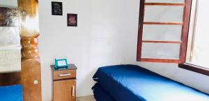 a bedroom with a blue bed and a window at Casa na Praia de Maresias in Maresias +35 photos