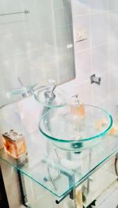 a glass sink in a bathroom with a mirror at Casa na Praia de Maresias in Maresias