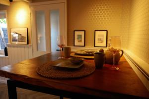 a wooden table with two glasses of wine on it at Studio Mañana in Cuijk +13 photos