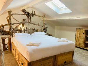 a bedroom with a large bed with a skylight at Manade des Baumelles in Saintes-Maries-de-la-Mer