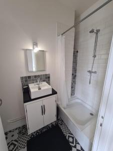 a white bathroom with a sink and a shower at Vivez Le Centre ville à la Plage - Balcon in Le Havre