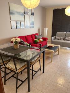 a living room with a red couch and a table at La Pituca in Playa Blanca +98 photos