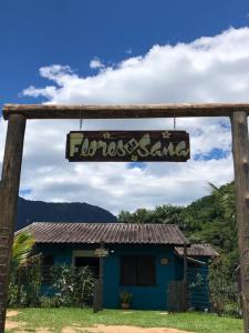 a sign that reads flosos island in front of a house at Chales Flores de Sana in Sana