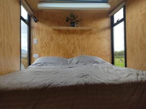 Postel nebo postele na pokoji v ubytování Quyé Tiny House