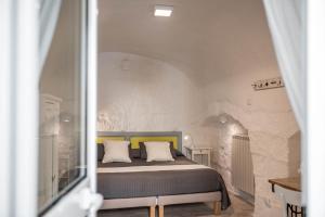 Posteľ alebo postele v izbe v ubytovaní Albergo Diffuso Monopoli