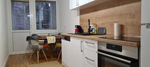 a kitchen with a counter top and a table and a window at Dino's spacious place in Sarajevo +10 photos