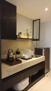 a kitchen with a sink and a counter top at Ruby Apartment #4 in Kejayan