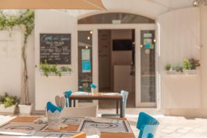 a restaurant with a table and chairs and a chalkboard at Albergo Diffuso Monopoli in Monopoli