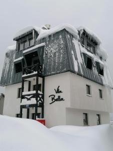 a building on top of a snow covered slope at Apartman Jahorina in Jahorina