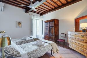 モンテプルチャーノにあるTenuta Golo Luxury Villa - Wine Estate with Pool near Montepulcianoのベッド2台とドレッサーのある寝室 +34枚の写真