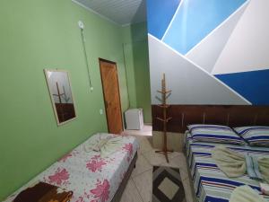 Cama o camas de una habitación en Suítes Pouso do Sol