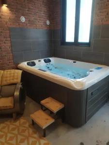 a large bath tub in a bathroom with a window at Spa Mensignac in Mensignac