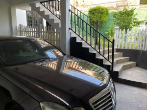 a black car parked in front of a house at Atrium Cottage in Seeduwa