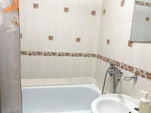 a bathroom with a tub and a toilet and a sink at Apartment on Astana 12/1 in Ustʼ-Kamenogorsk +11 photos